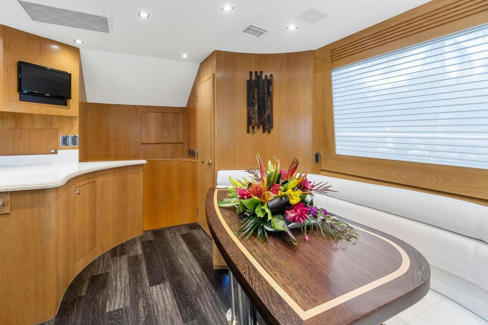 a room with a table and a television aboard BELLISSIMA Yacht for Sale