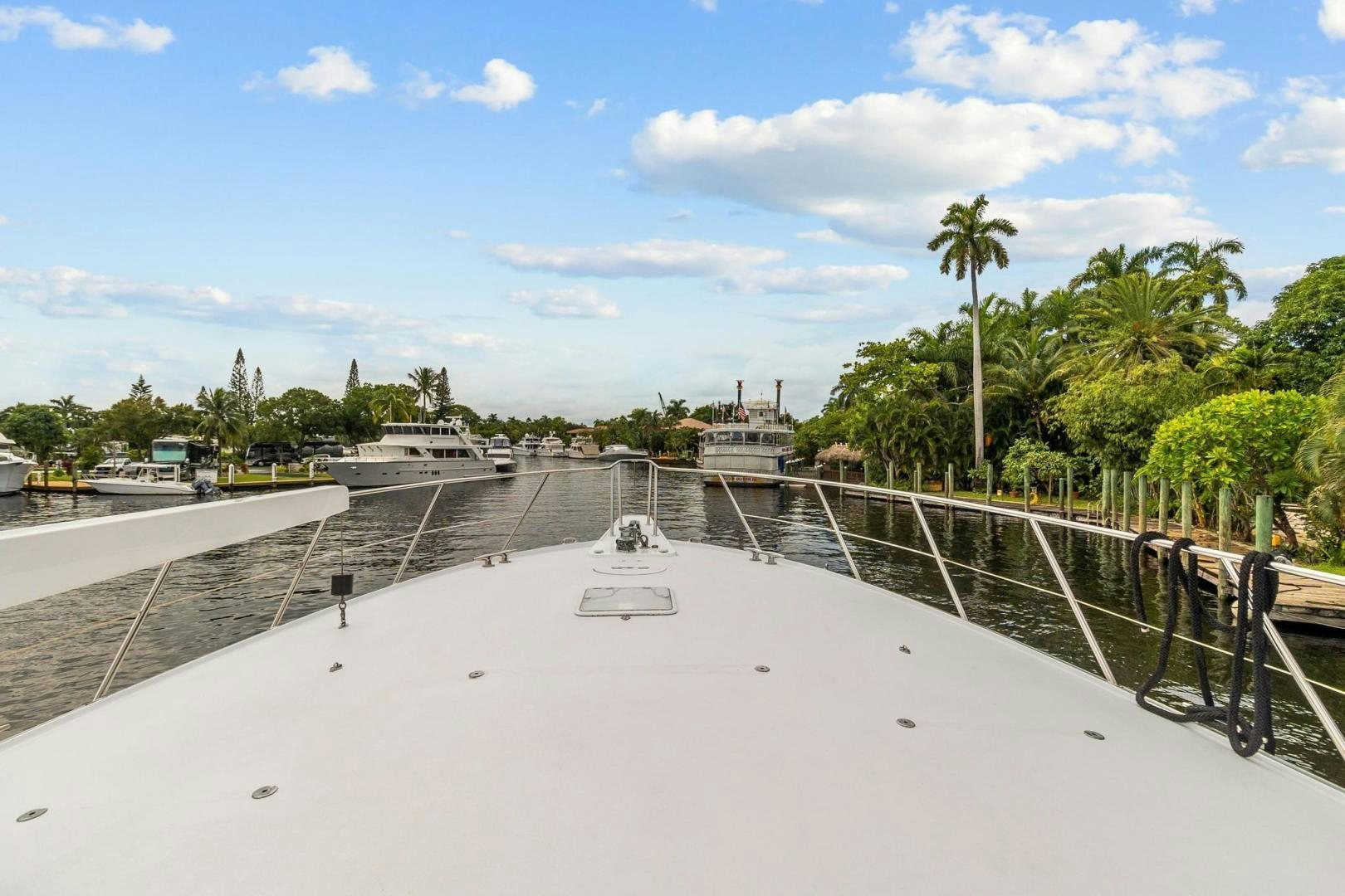 a large white sand dune with palm trees and a building in the background aboard BELLISSIMA Yacht for Sale