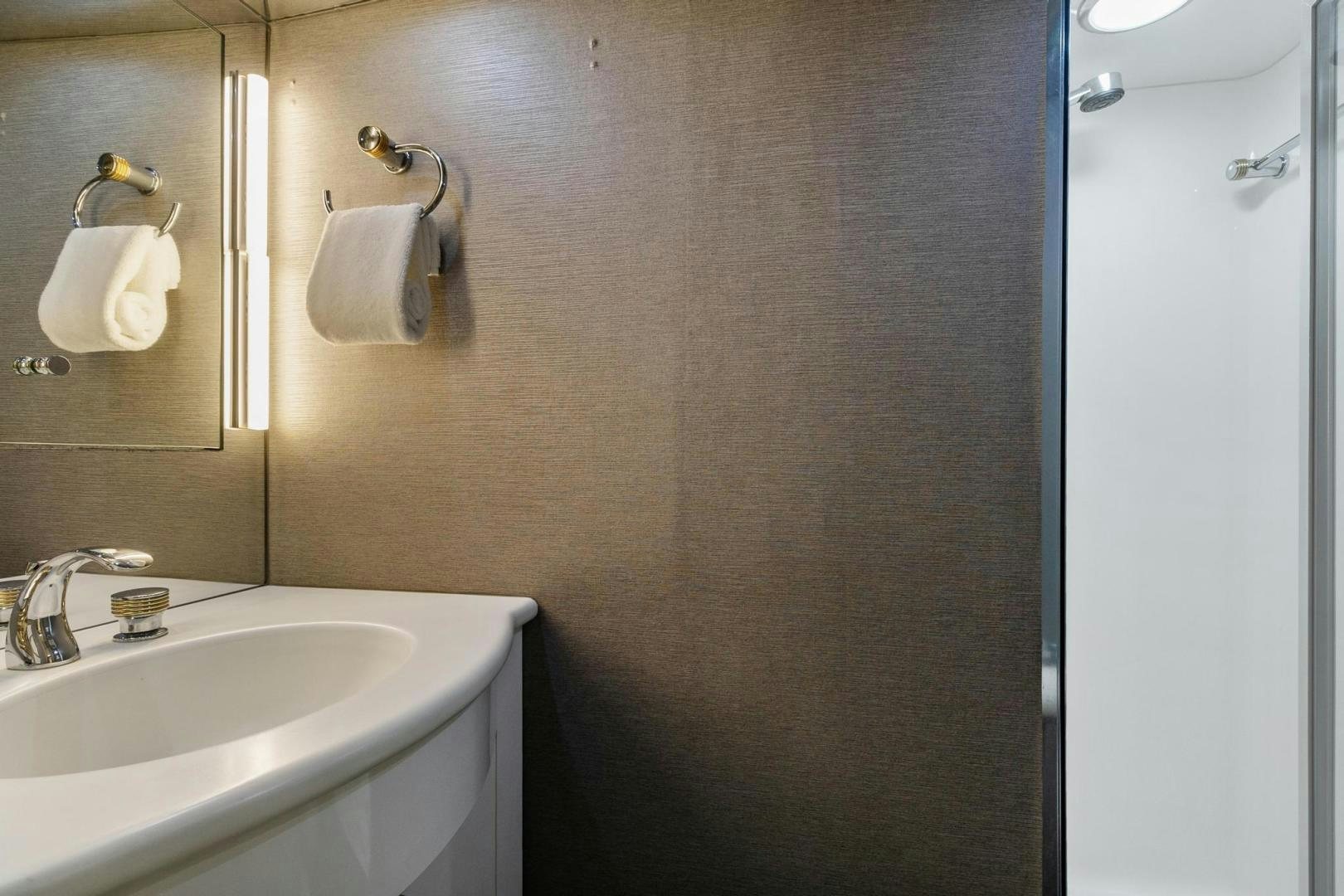 a bathroom with a sink and a mirror aboard BELLISSIMA Yacht for Sale