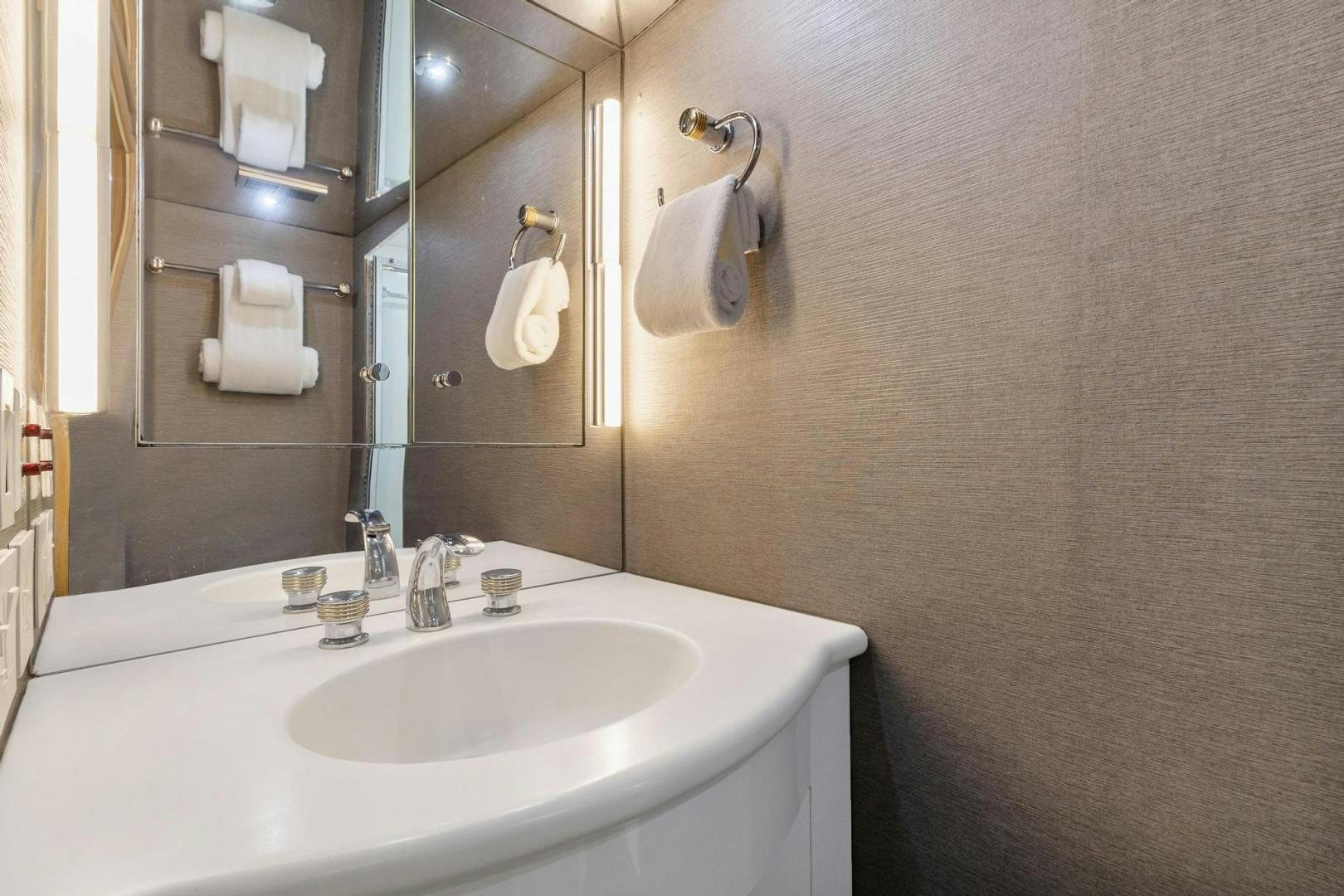 a bathroom with a sink and towels aboard BELLISSIMA Yacht for Sale