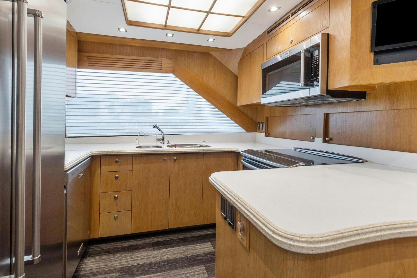 a kitchen with wooden cabinets aboard BELLISSIMA Yacht for Sale