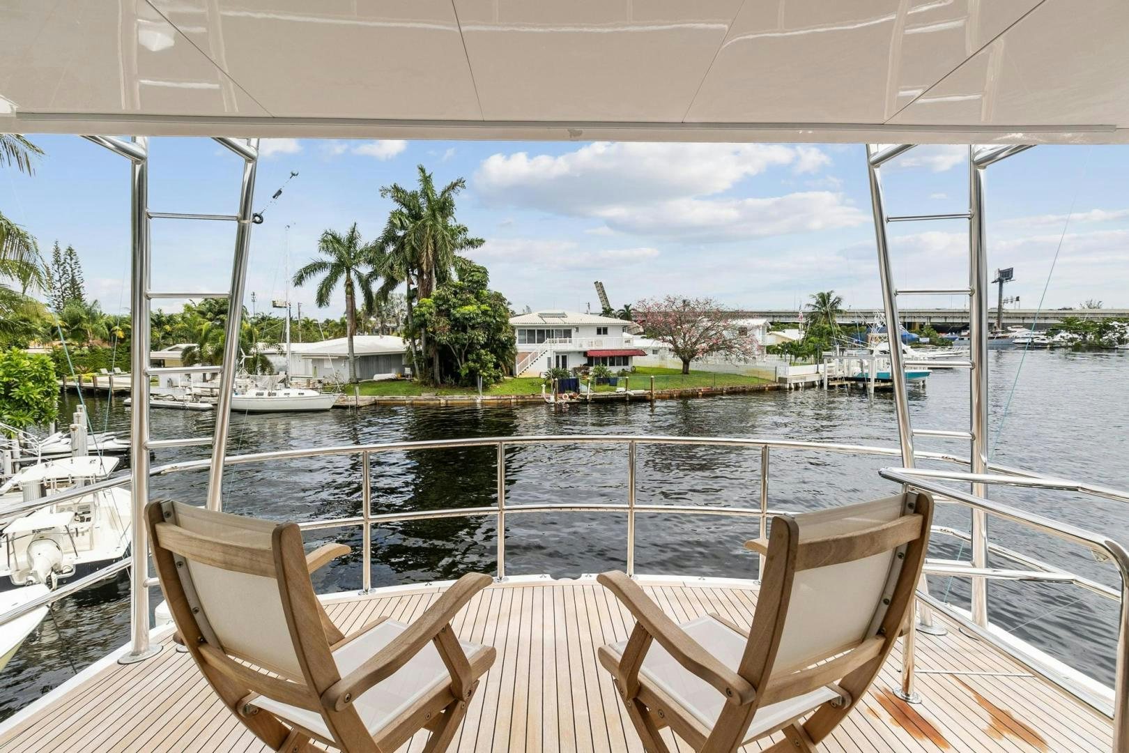 a deck with chairs and a body of water with boats in it aboard BELLISSIMA Yacht for Sale