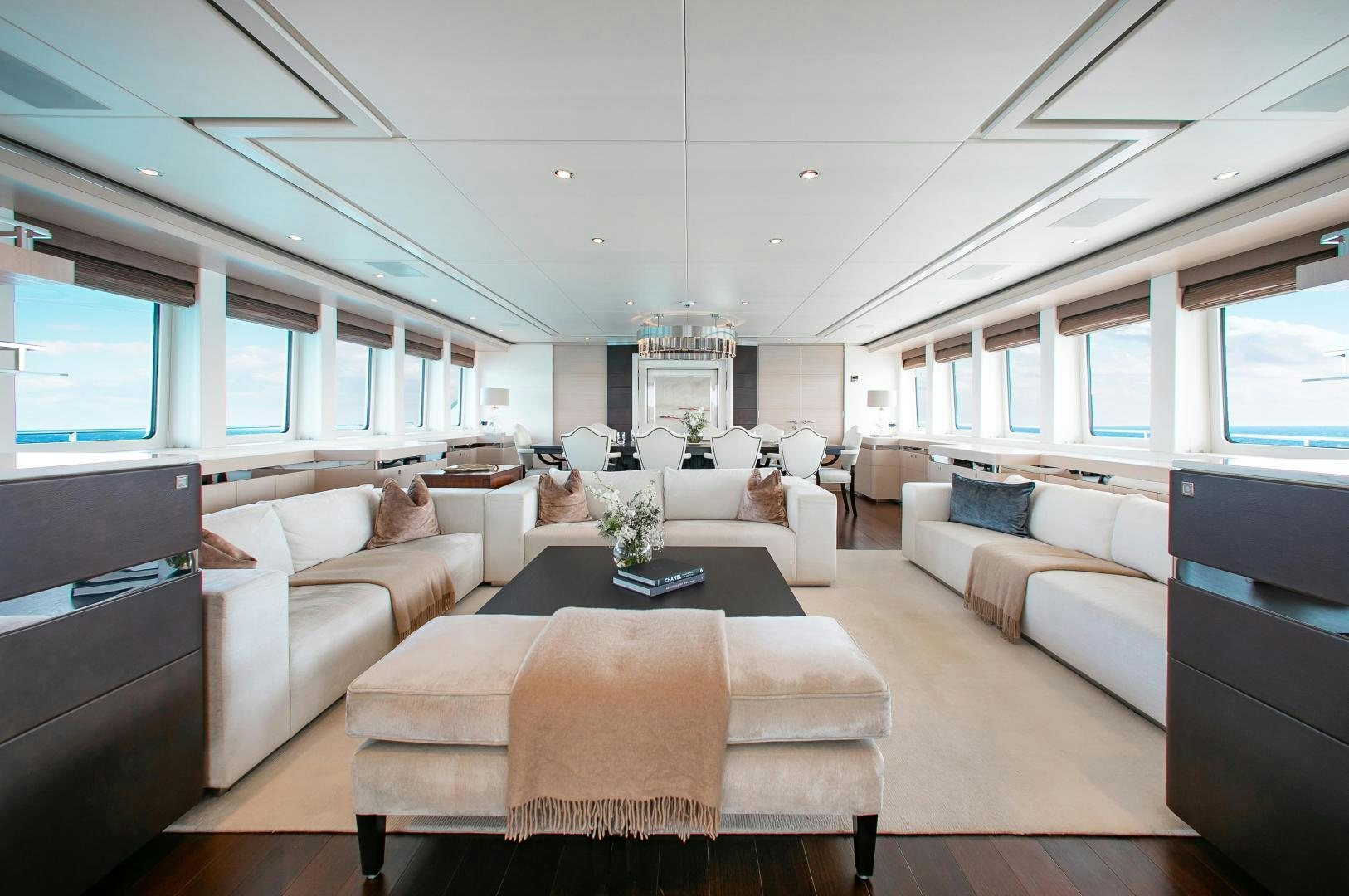 a living room with white couches aboard LADY L Yacht for Charter