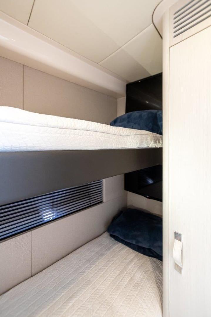 a bed with a white sheet aboard BLESSED Yacht for Sale
