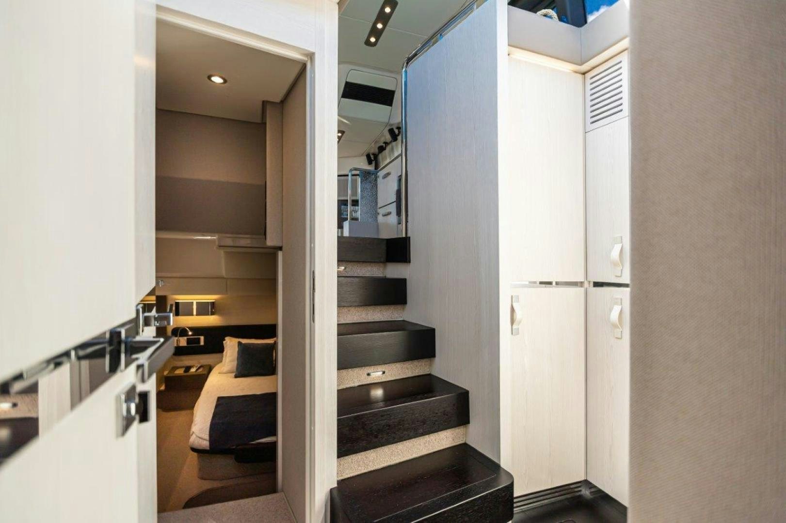 a room with a staircase and a couch aboard BLESSED Yacht for Sale