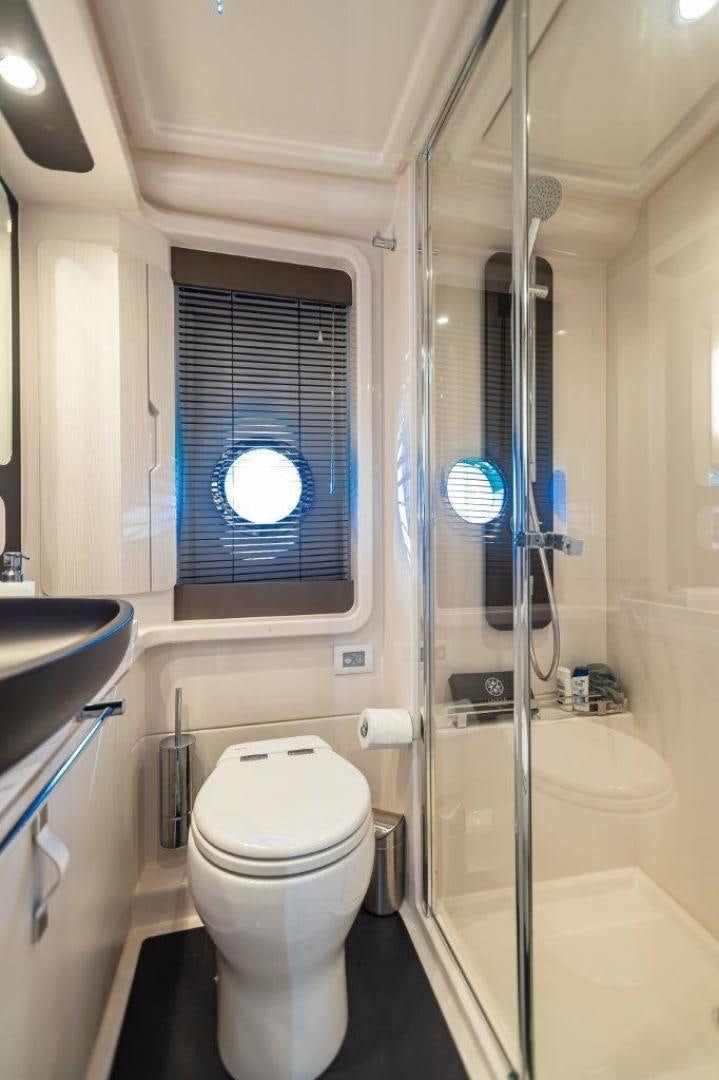 a bathroom with a glass shower aboard BLESSED Yacht for Sale