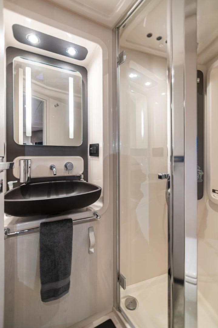 a bathroom with a sink and a mirror aboard BLESSED Yacht for Sale