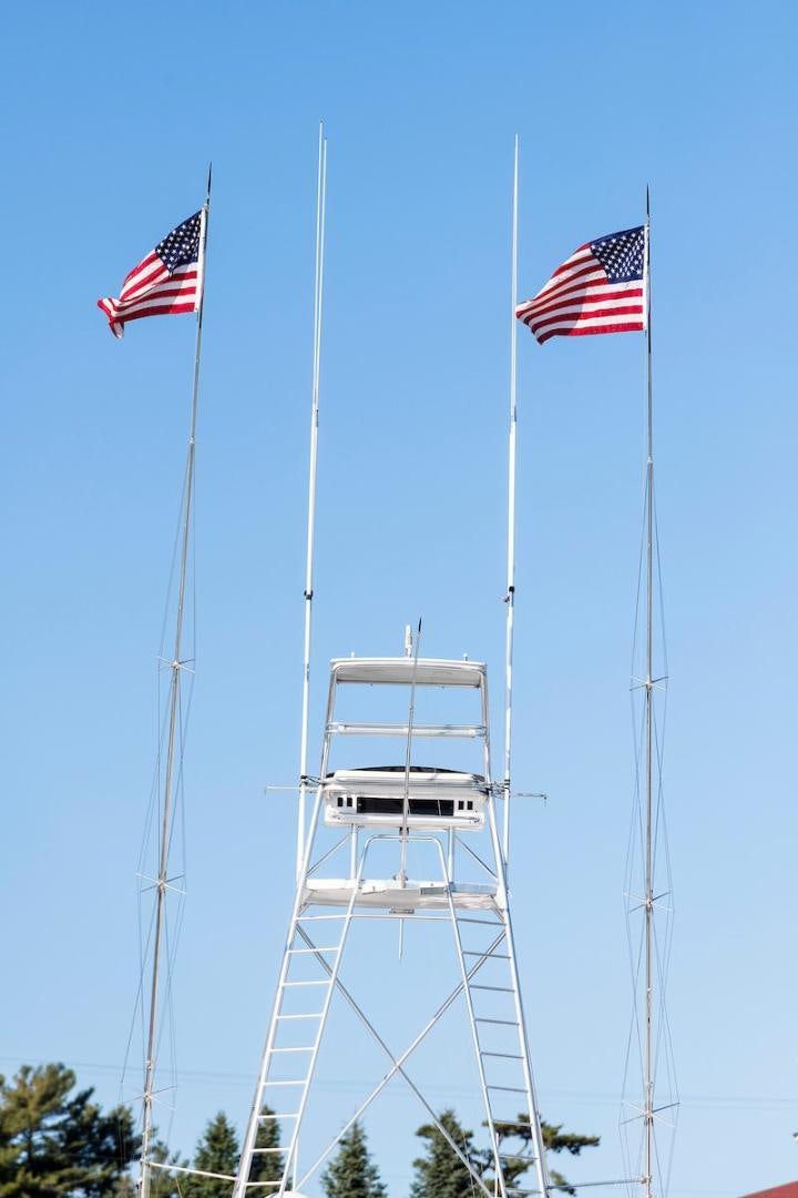 a flag on a pole with a flag on it aboard ADVENTURER Yacht for Sale