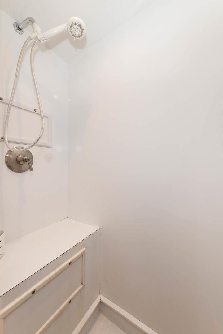 a shower with a white wall aboard ADVENTURER Yacht for Sale