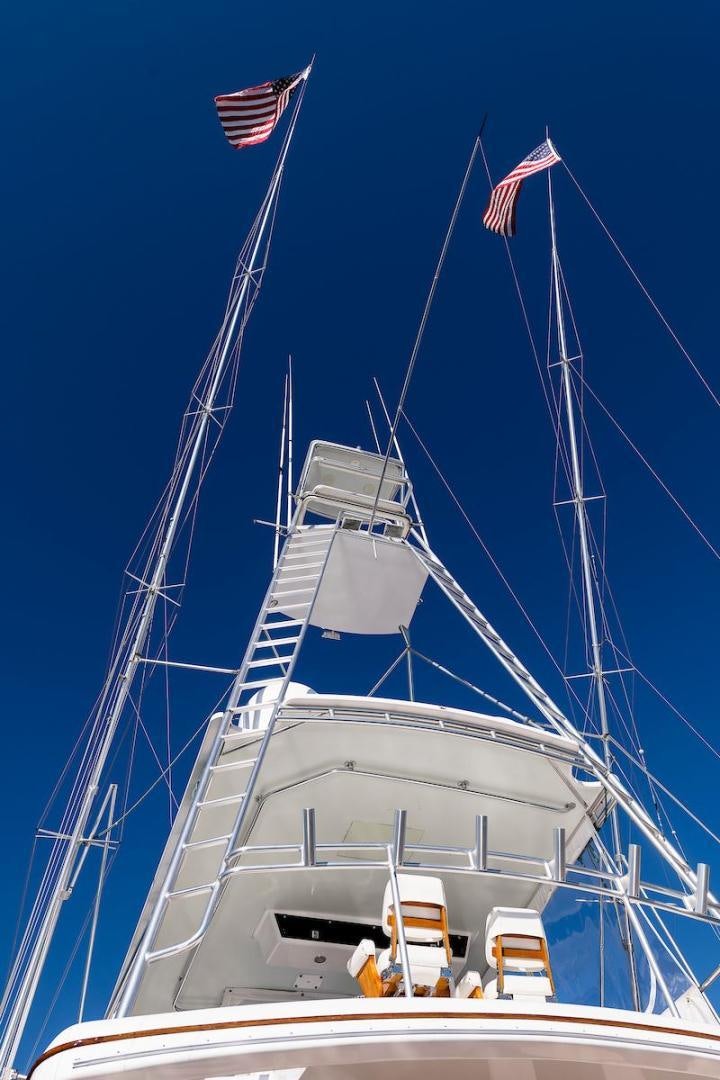 a boat with a flag on the front aboard ADVENTURER Yacht for Sale