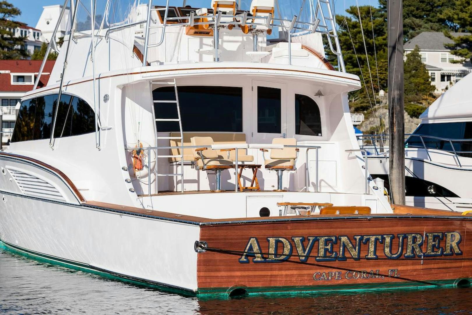 a boat with a deck and chairs aboard ADVENTURER Yacht for Sale