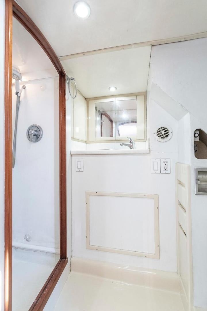 a white cabinet with a mirror aboard ADVENTURER Yacht for Sale