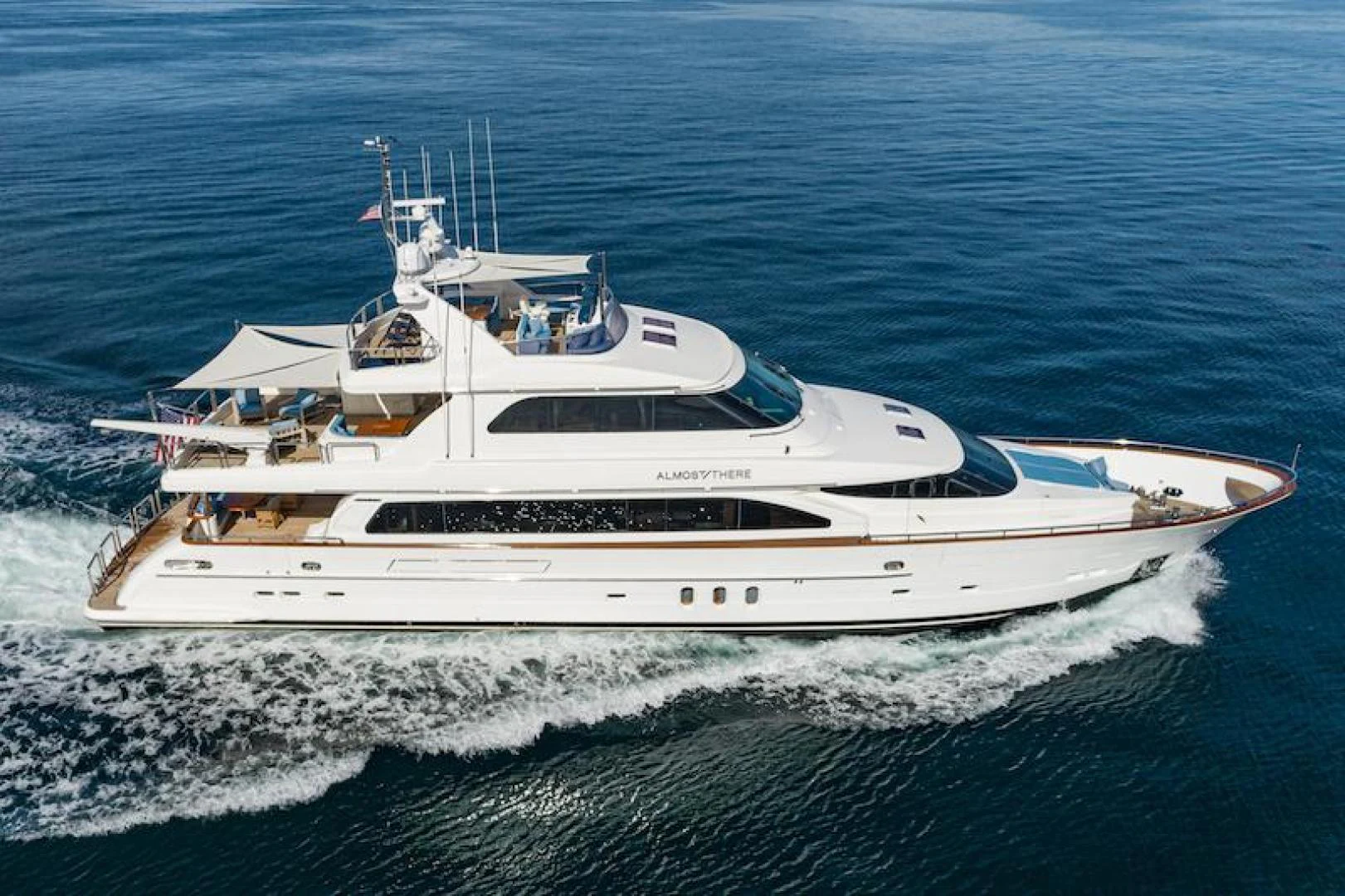a white yacht on the water aboard ALMOST THERE Yacht for Sale