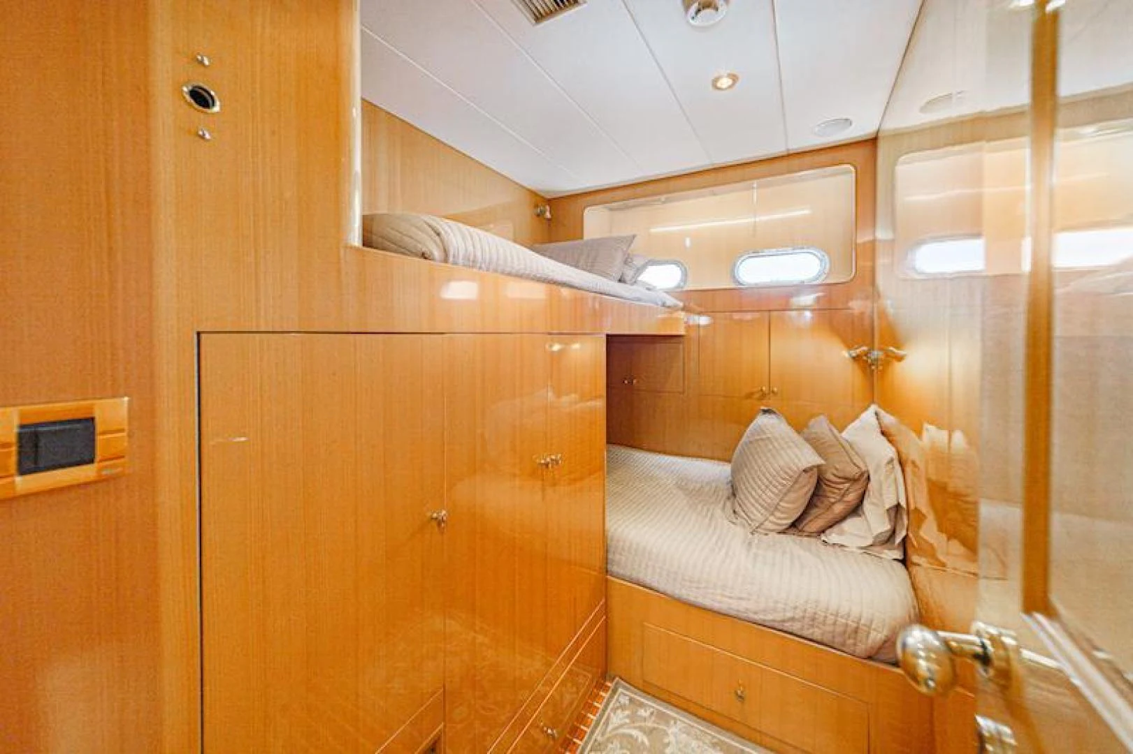 a room with a bed and a wood cabinet aboard ALMOST THERE Yacht for Sale