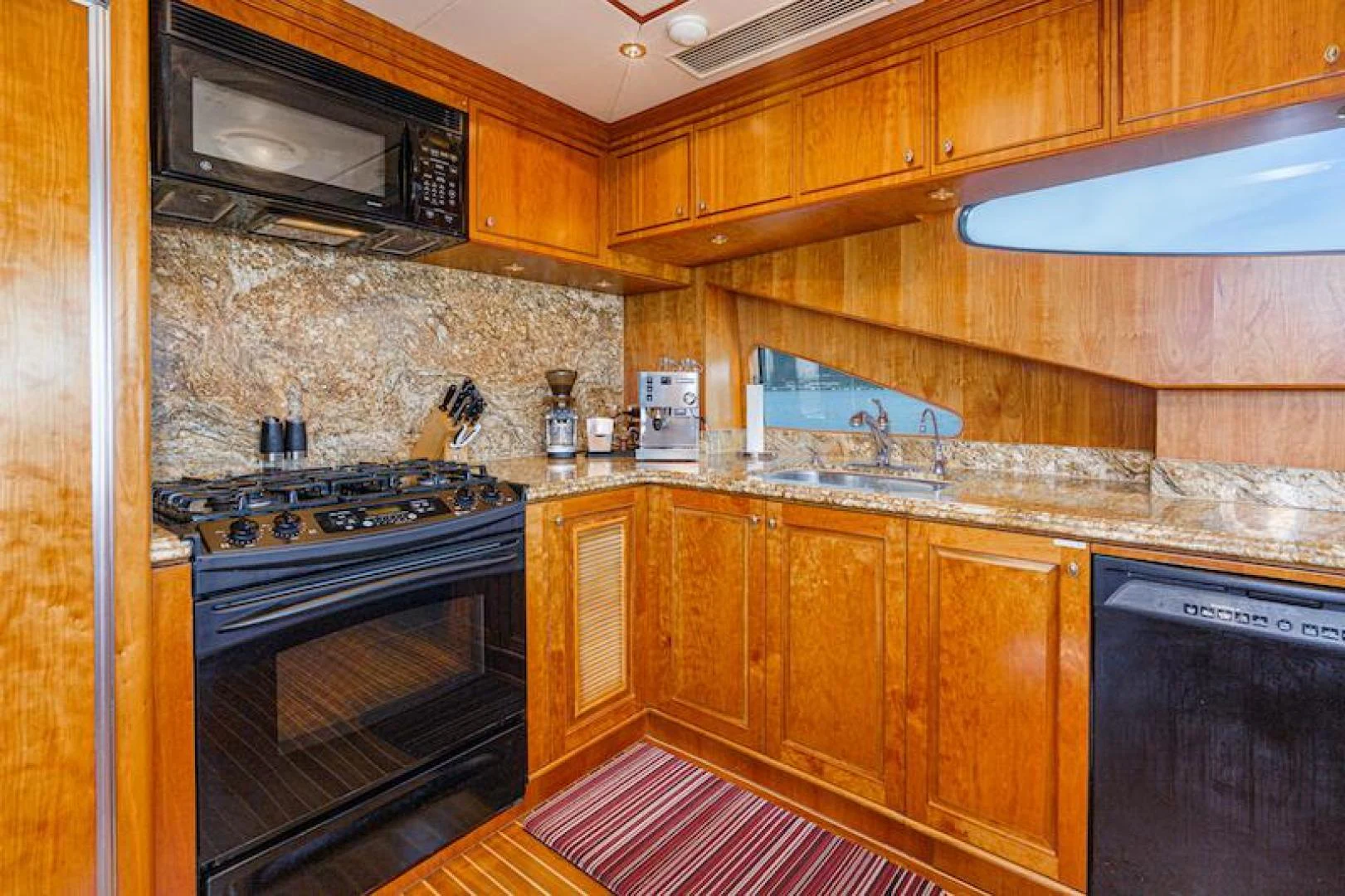 a kitchen with wooden cabinets aboard ALMOST THERE Yacht for Sale