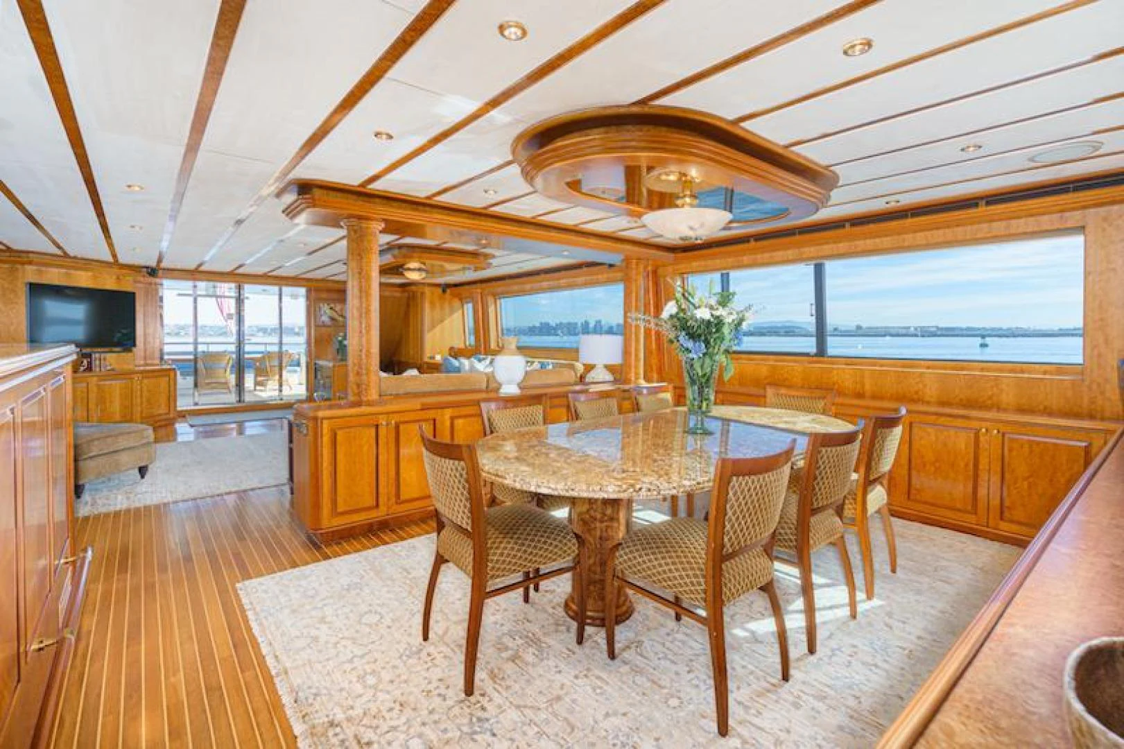 a large dining room with a wood table and chairs aboard ALMOST THERE Yacht for Sale