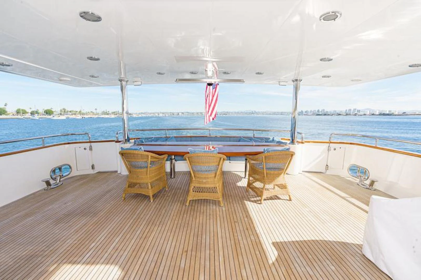 a deck with chairs and tables on it by the water aboard ALMOST THERE Yacht for Sale