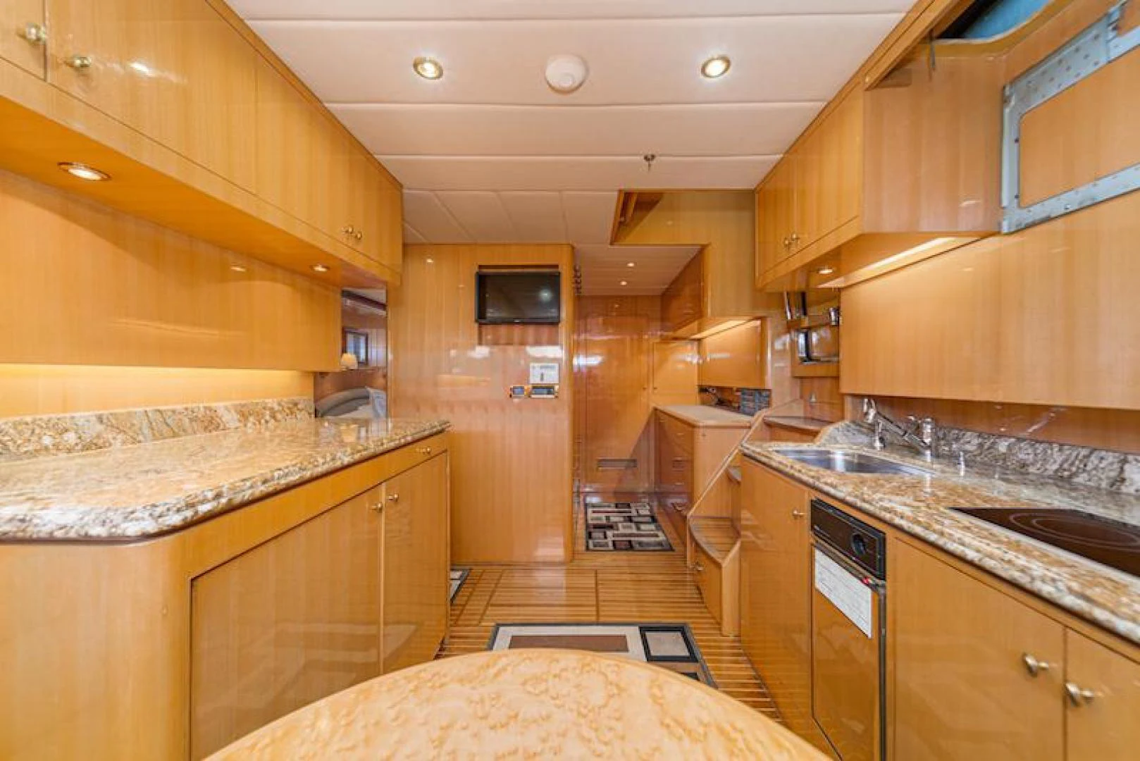a kitchen with wooden cabinets aboard ALMOST THERE Yacht for Sale