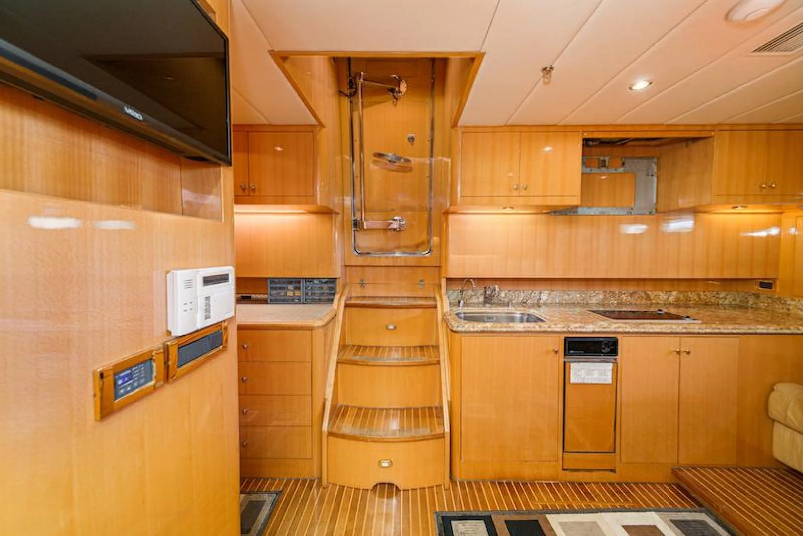 a kitchen with wooden cabinets aboard ALMOST THERE Yacht for Sale