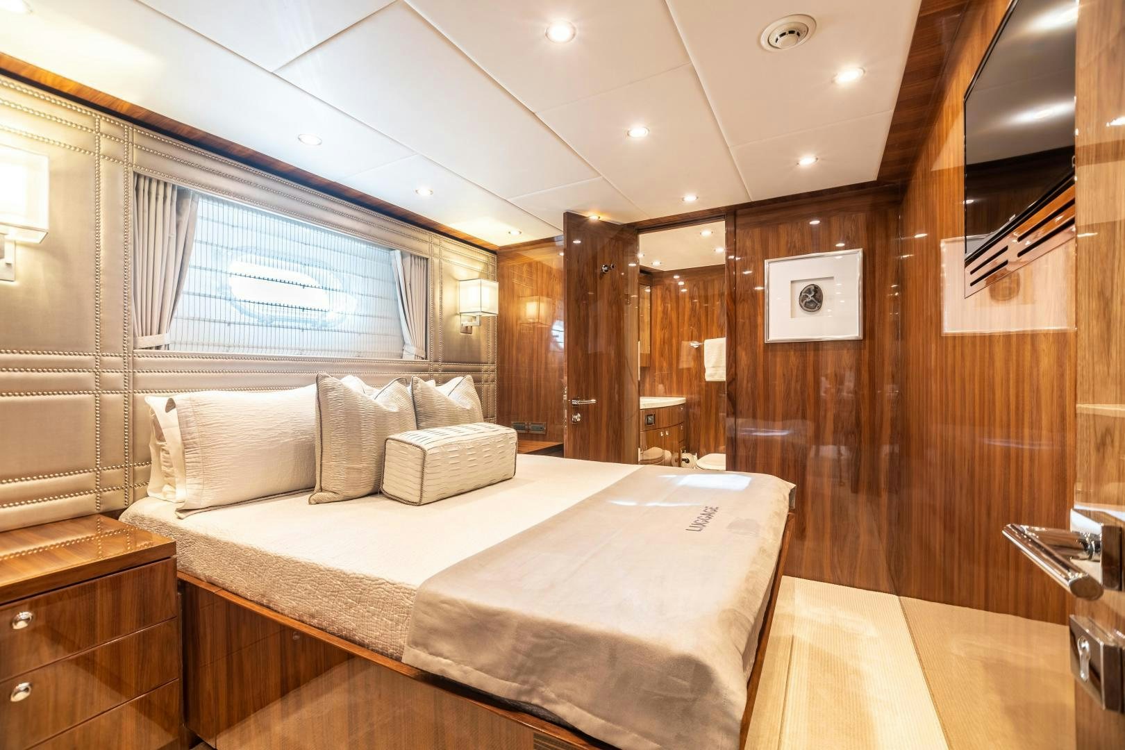 a bedroom with a bed and a mirror aboard CUTTING EDGE Yacht for Sale