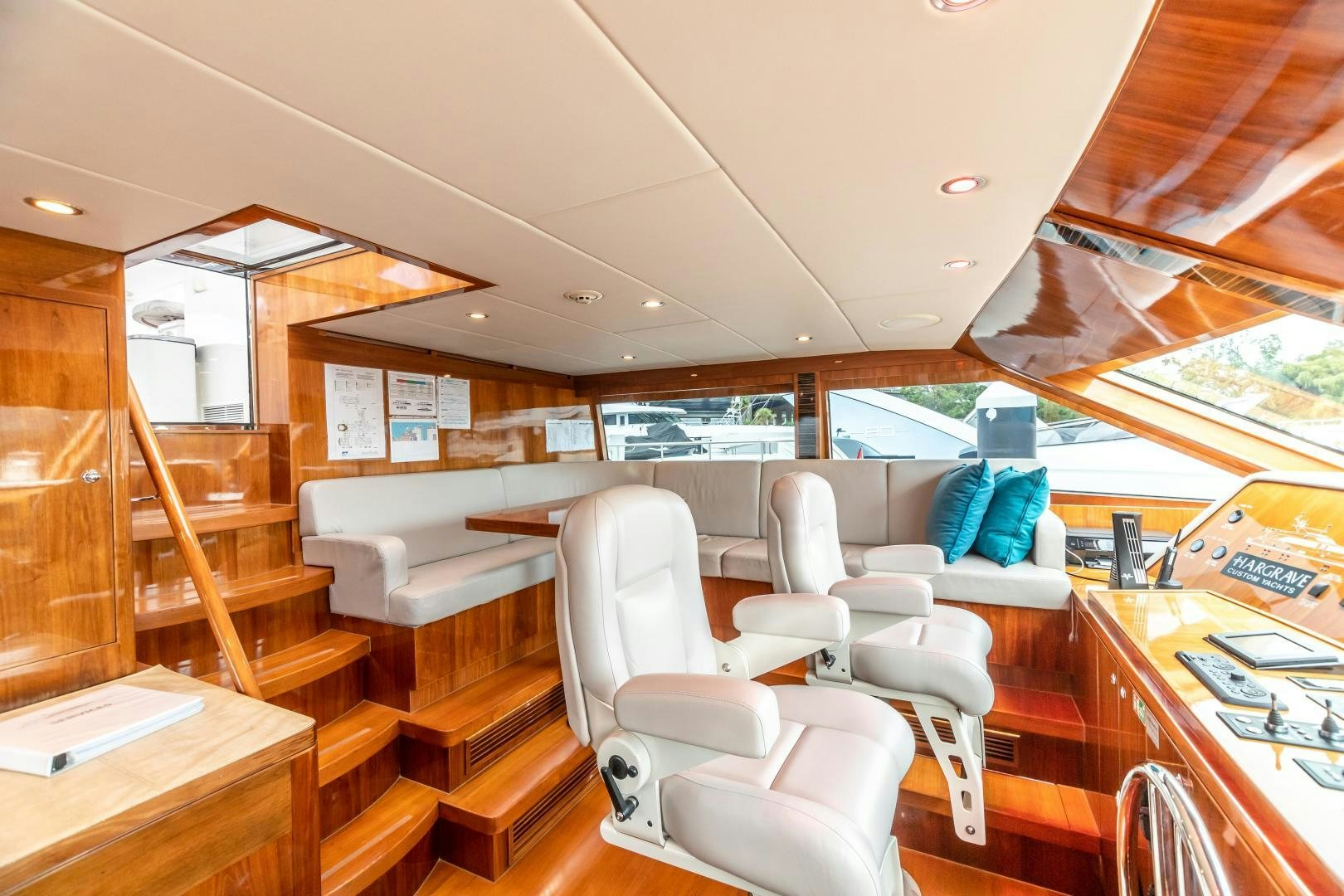 a room with a table chairs and a large window aboard CUTTING EDGE Yacht for Sale