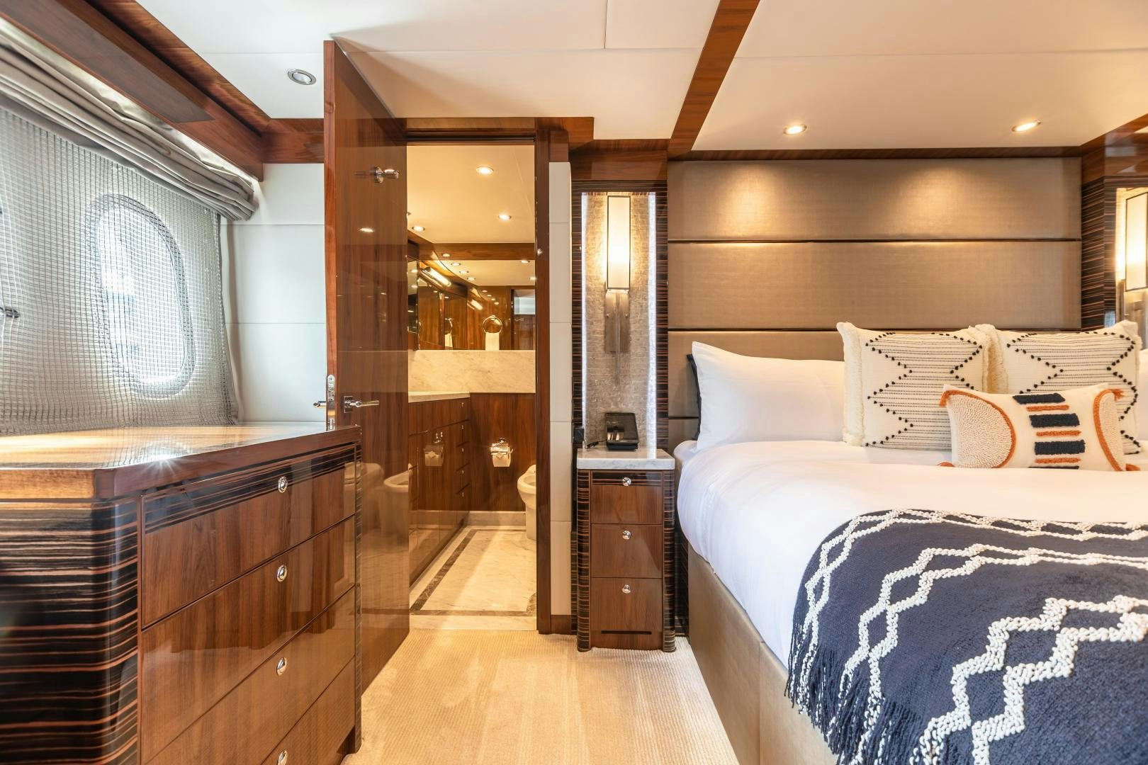 a bedroom with a bed and a dresser aboard CUTTING EDGE Yacht for Sale