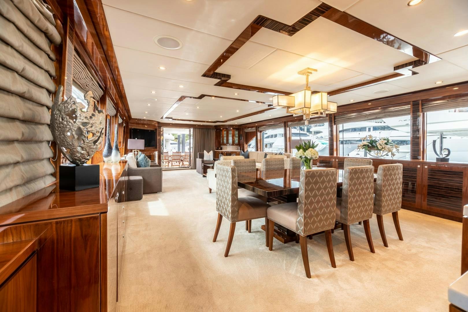 a room with a table chairs and a large window aboard CUTTING EDGE Yacht for Sale