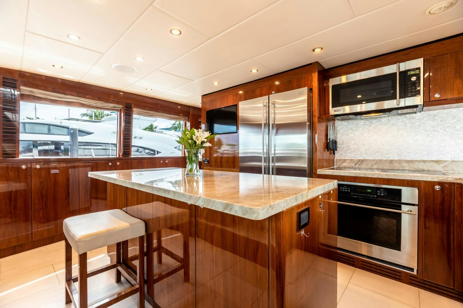 a kitchen with a stainless steel island aboard CUTTING EDGE Yacht for Sale
