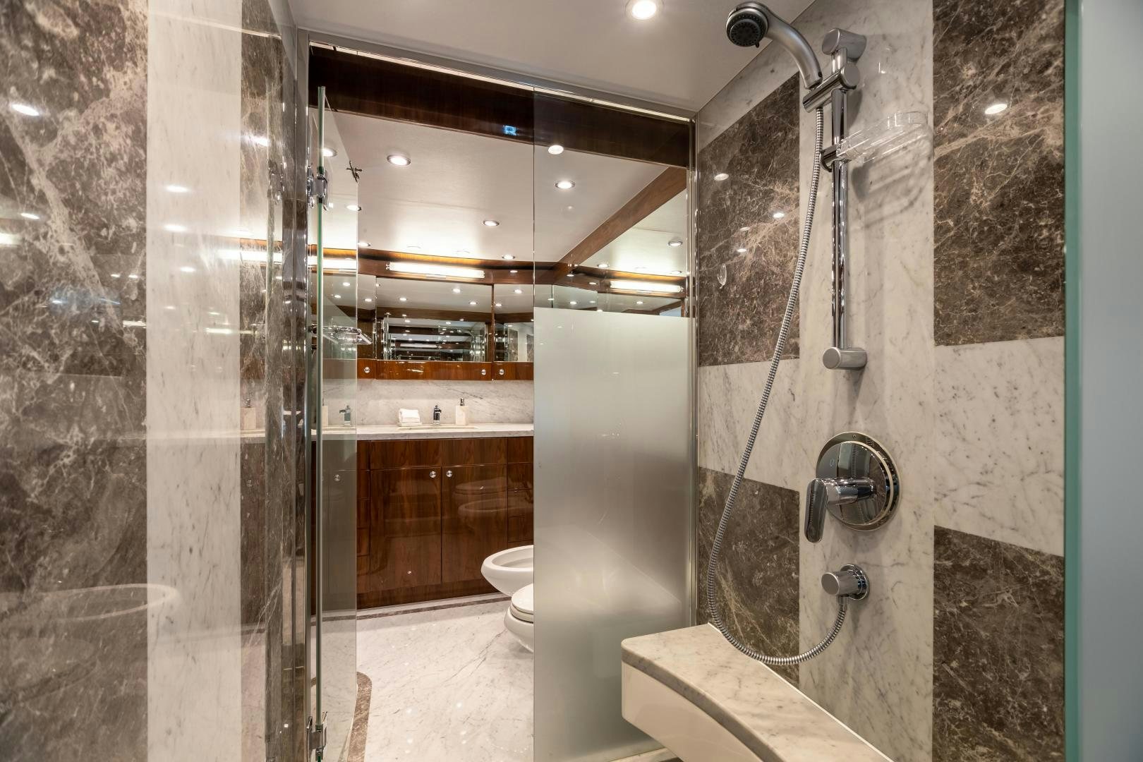 a bathroom with a glass shower aboard CUTTING EDGE Yacht for Sale