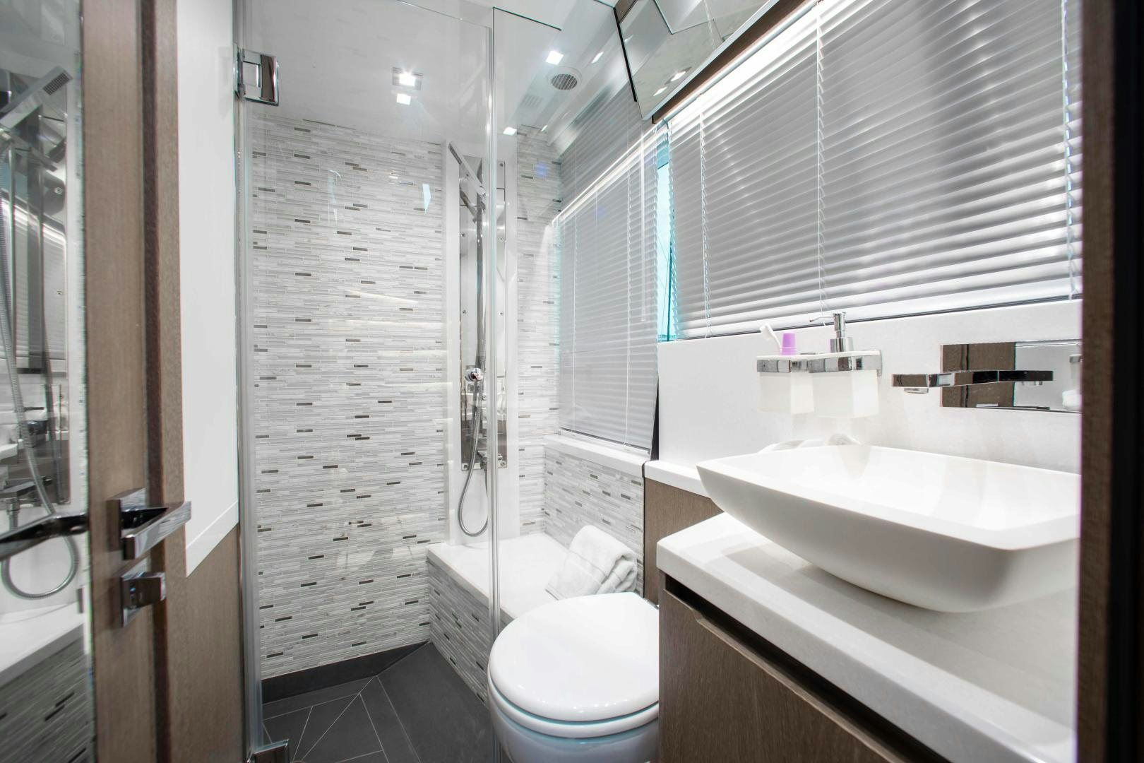a bathroom with a sink toilet and shower aboard LYLA BEE Yacht for Sale