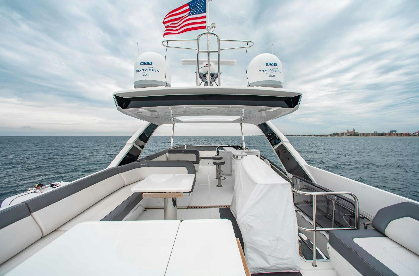 a boat with a flag on the front aboard LYLA BEE Yacht for Sale
