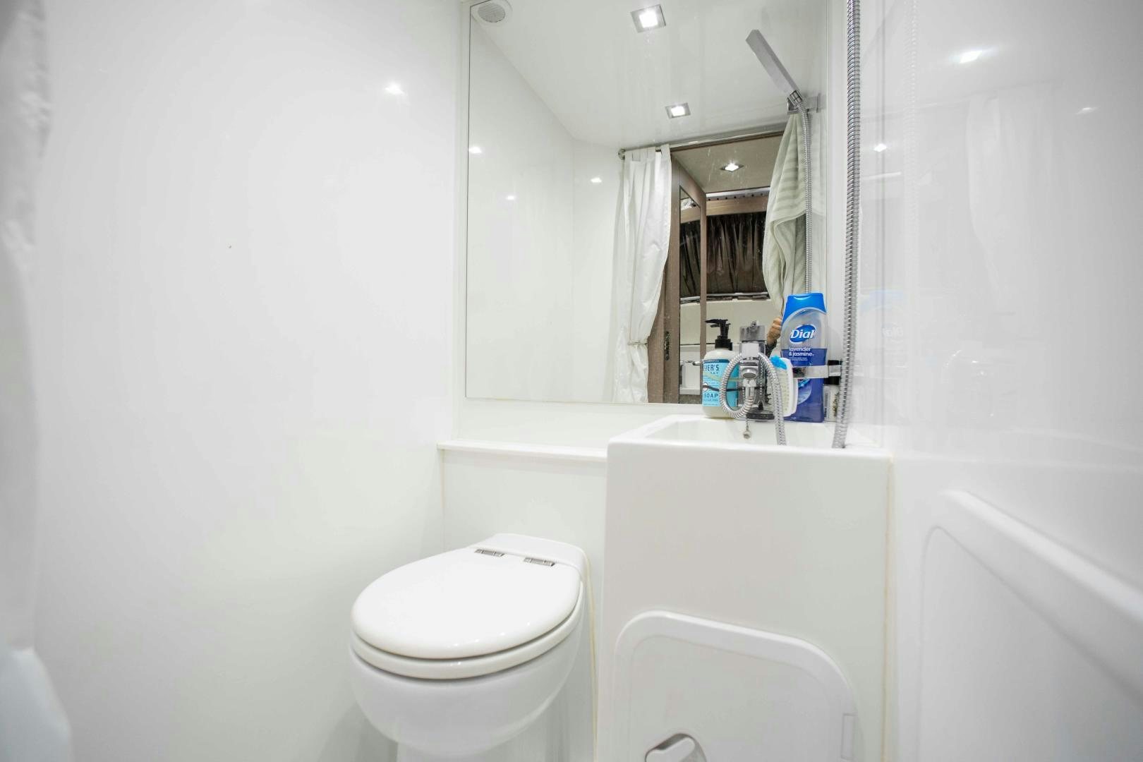 a bathroom with a toilet and a sink aboard LYLA BEE Yacht for Sale