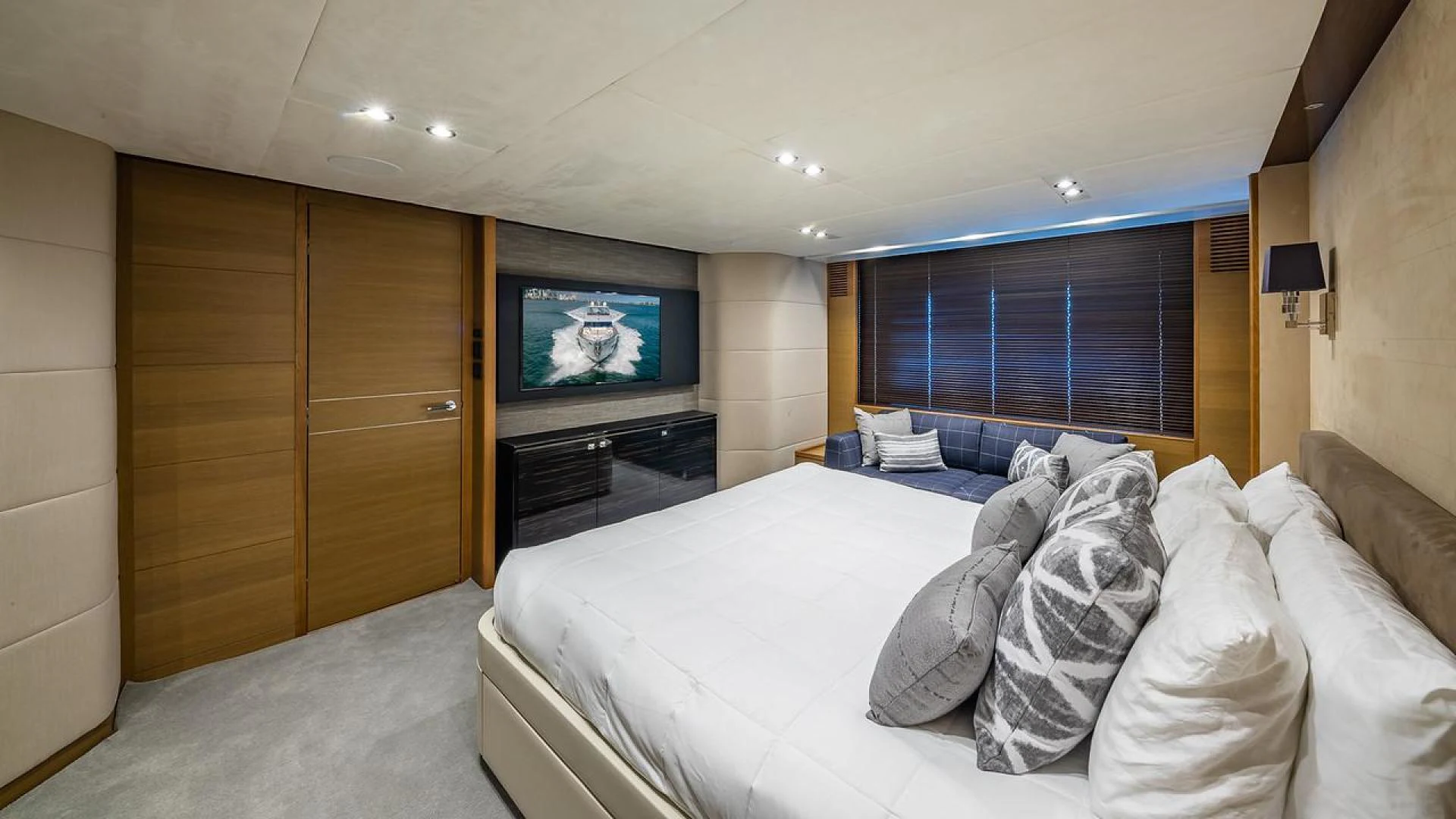 a bed with a television on the wall aboard FREEDOM Yacht for Sale