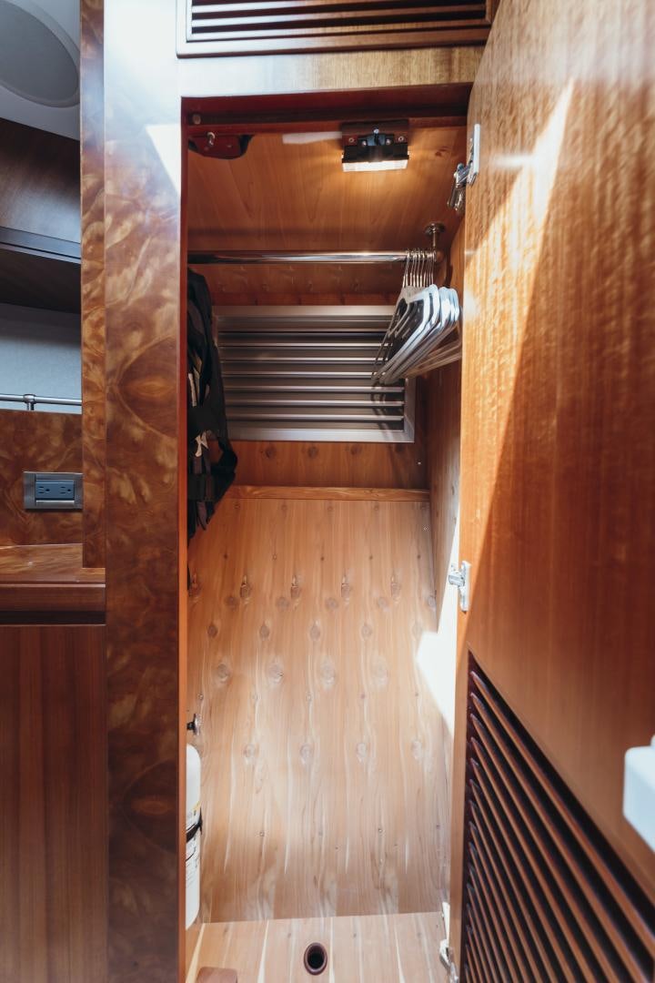 a wooden staircase with a wood railing aboard SKULLDUGGERY Yacht for Sale