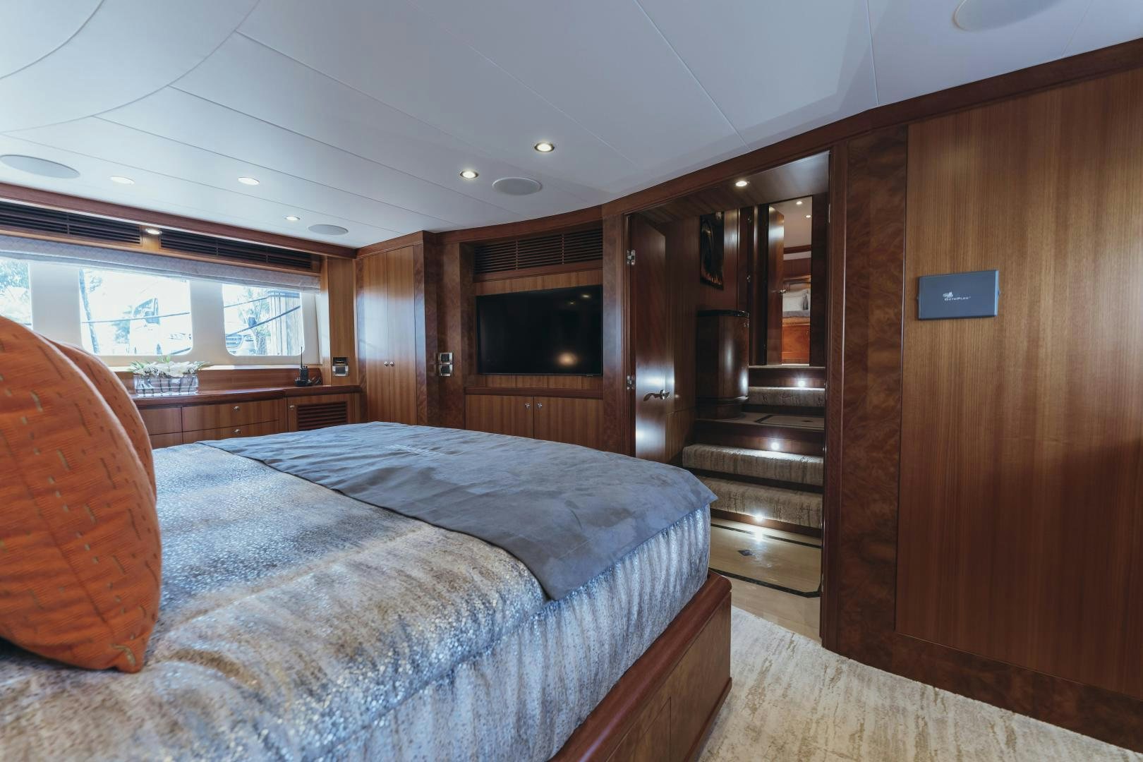 a bedroom with a bed and a wood door aboard SKULLDUGGERY Yacht for Sale