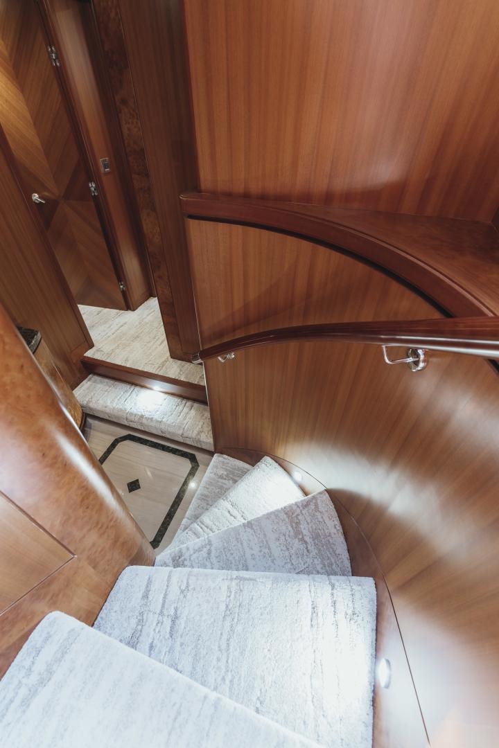 a wooden staircase with a white rug aboard SKULLDUGGERY Yacht for Sale