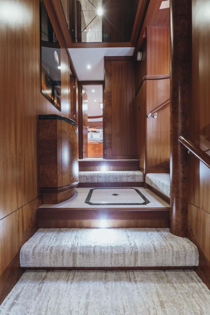 a room with a fireplace and wood cabinets aboard SKULLDUGGERY Yacht for Sale