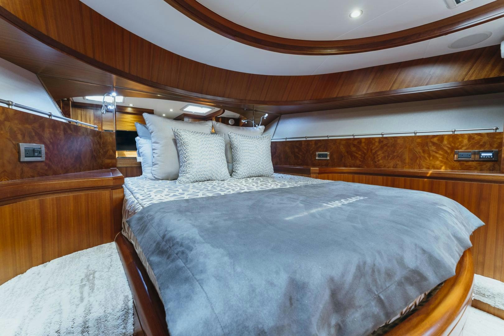 a bed with a wooden headboard aboard SKULLDUGGERY Yacht for Sale