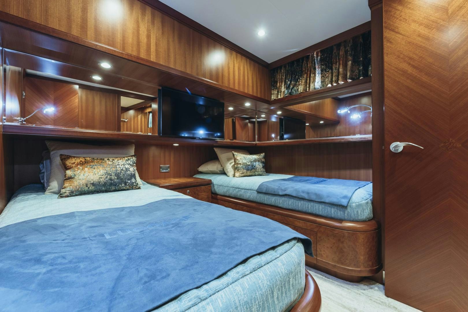 a room with a bed and a television aboard SKULLDUGGERY Yacht for Sale