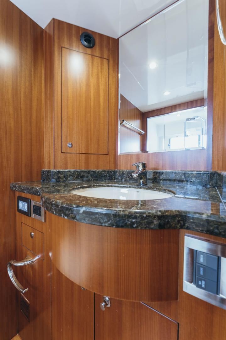a kitchen with a sink and wooden cabinets aboard SKULLDUGGERY Yacht for Sale
