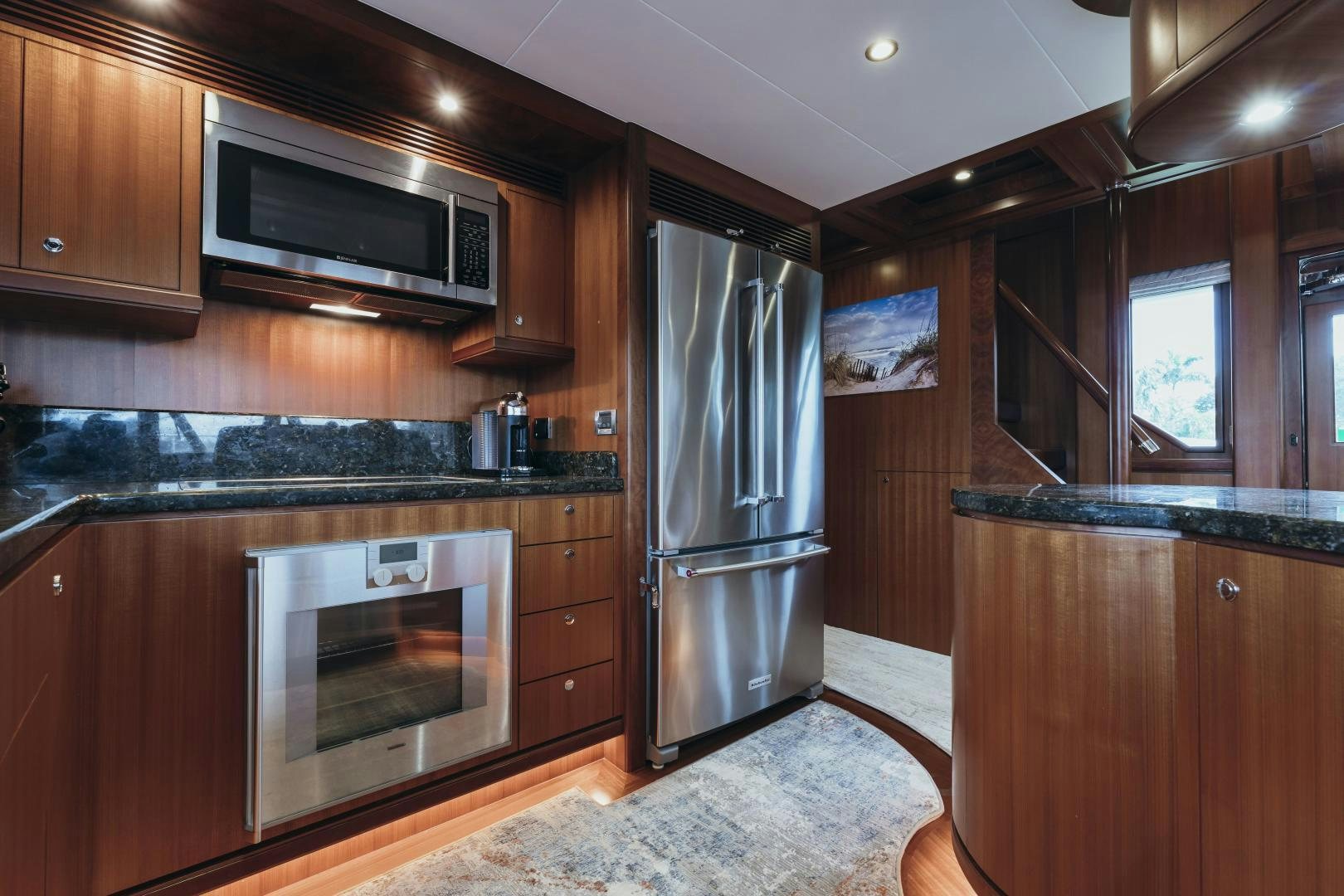 a kitchen with wooden cabinets aboard SKULLDUGGERY Yacht for Sale