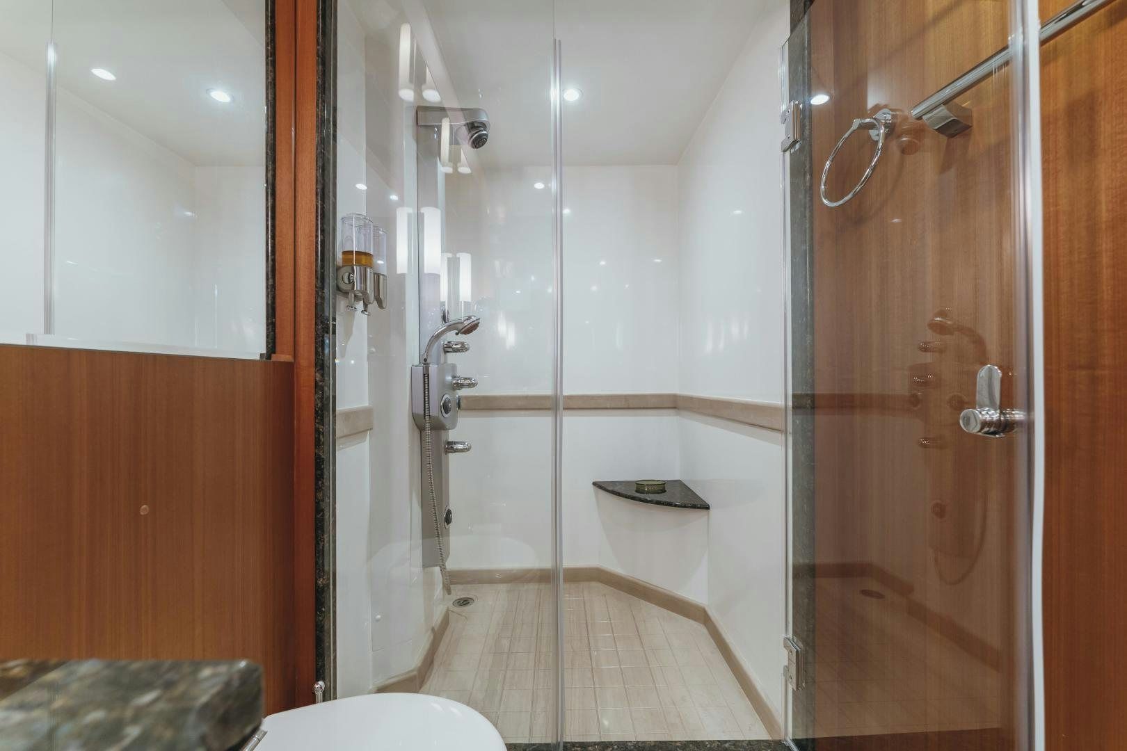 a bathroom with a glass shower aboard SKULLDUGGERY Yacht for Sale