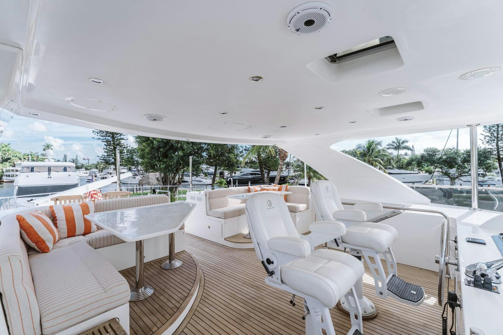 a room with a large white lounge chair and a large pool aboard SKULLDUGGERY Yacht for Sale
