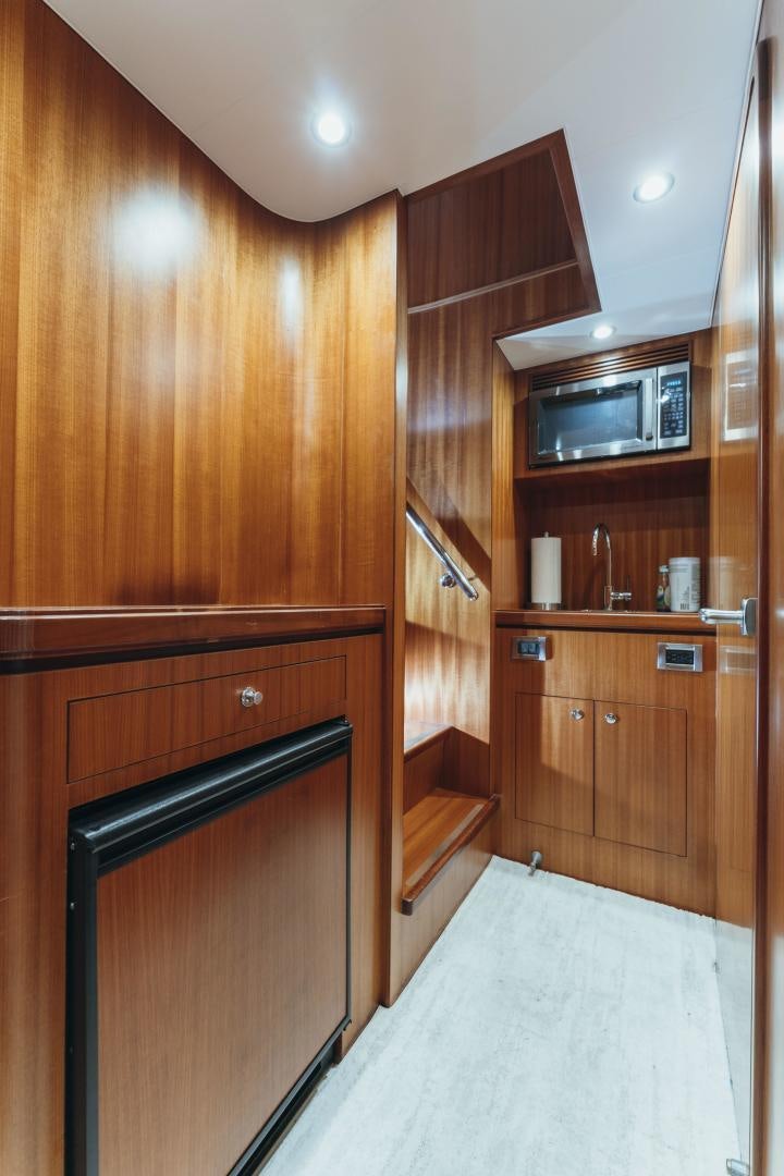 a kitchen with wooden cabinets aboard SKULLDUGGERY Yacht for Sale