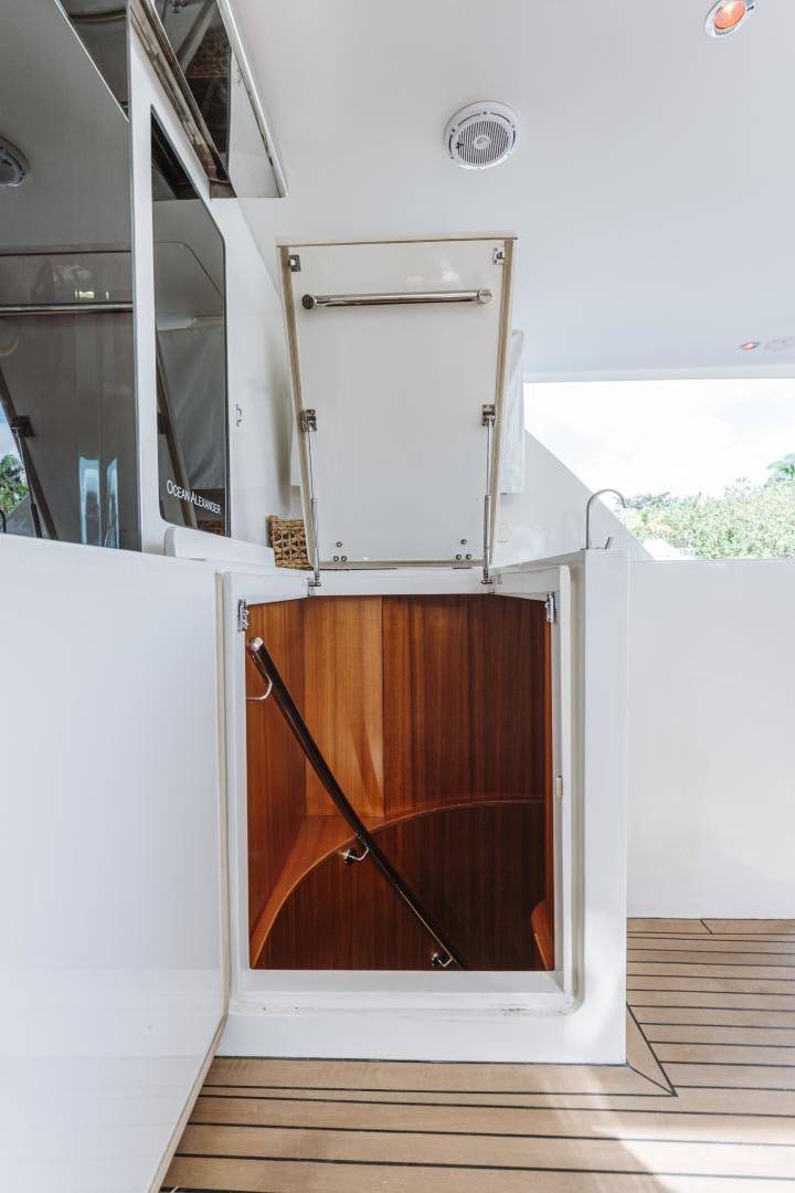 a white refrigerator and a wooden cabinet aboard SKULLDUGGERY Yacht for Sale