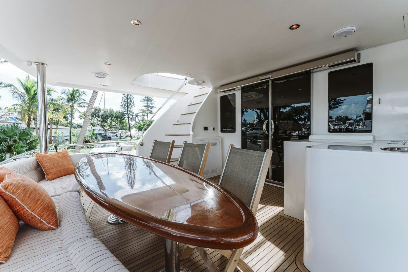 a large living room with a table and chairs aboard SKULLDUGGERY Yacht for Sale