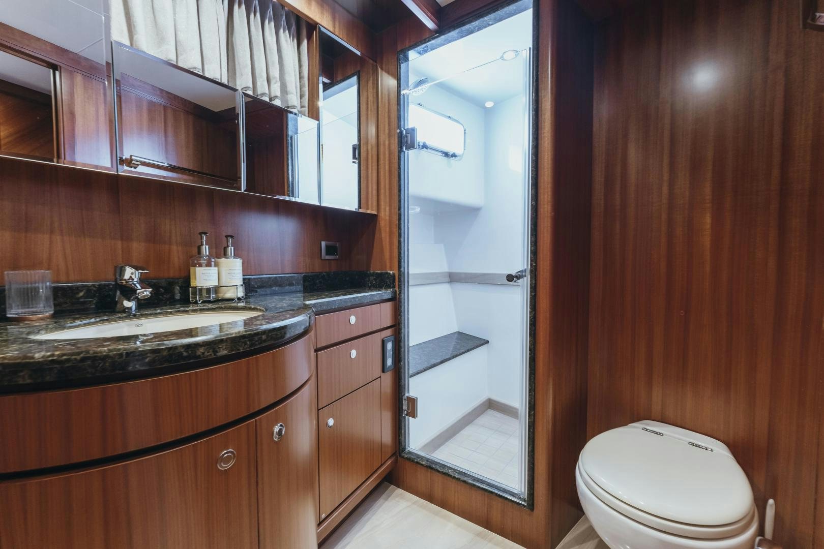 a bathroom with a glass shower door aboard SKULLDUGGERY Yacht for Sale