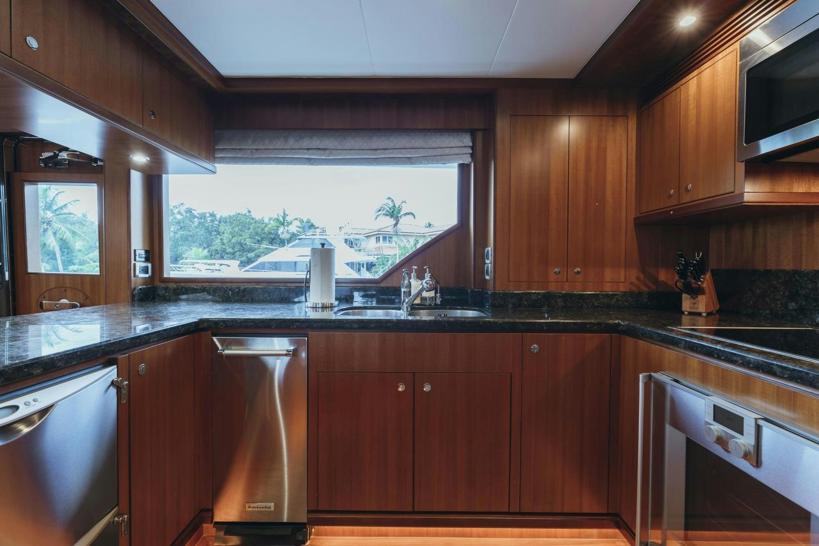 a kitchen with wooden cabinets aboard SKULLDUGGERY Yacht for Sale