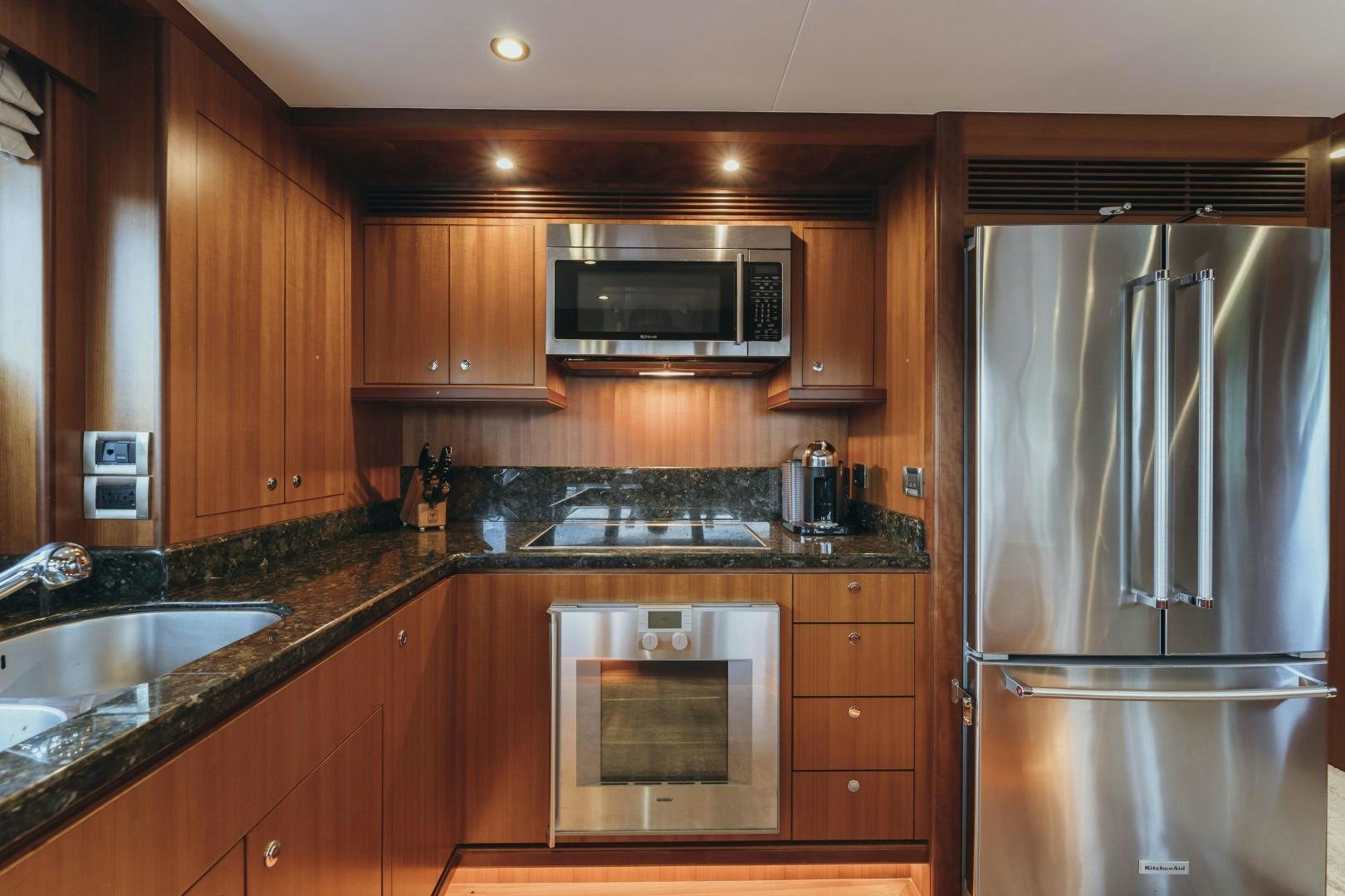 a kitchen with wooden cabinets aboard SKULLDUGGERY Yacht for Sale