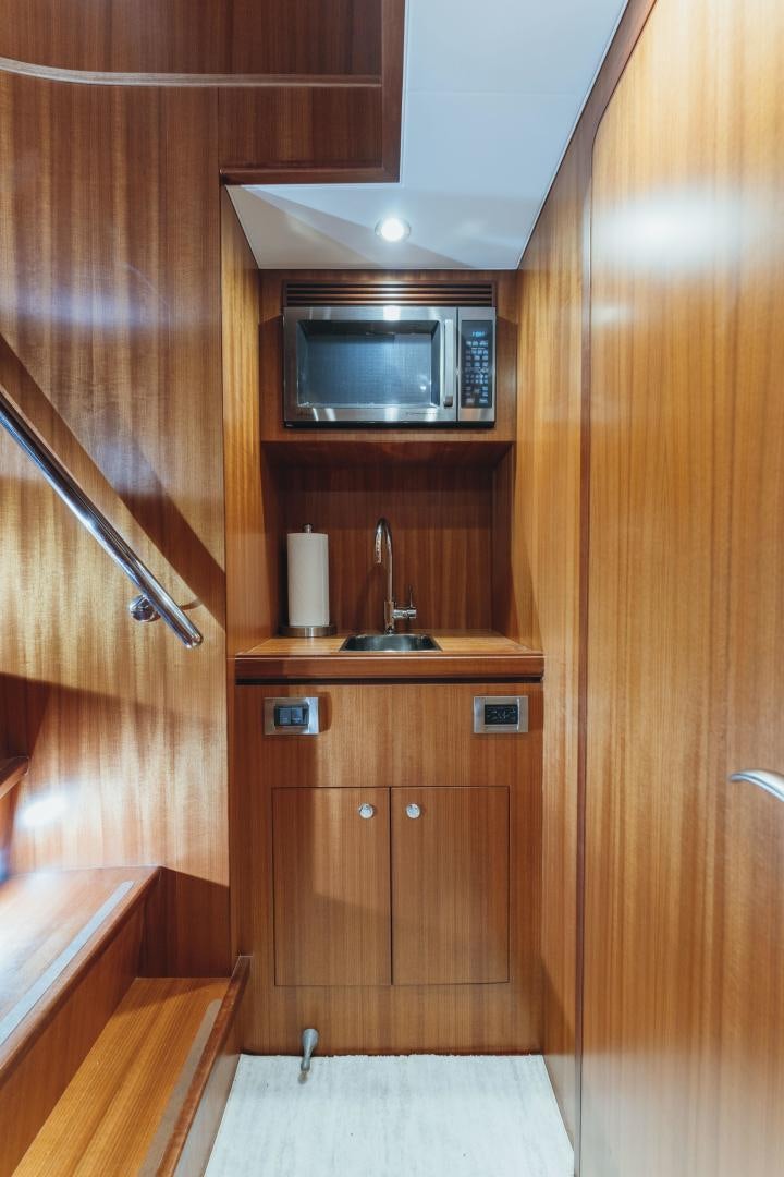 a kitchen with wooden cabinets aboard SKULLDUGGERY Yacht for Sale